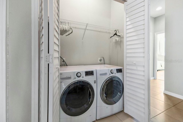 laundry area featuring light tile patterned floors and independent washer and dryer