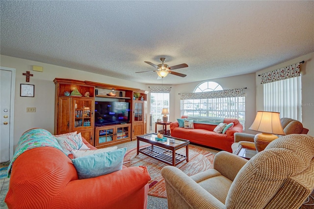 living room with a textured ceiling and ceiling fan