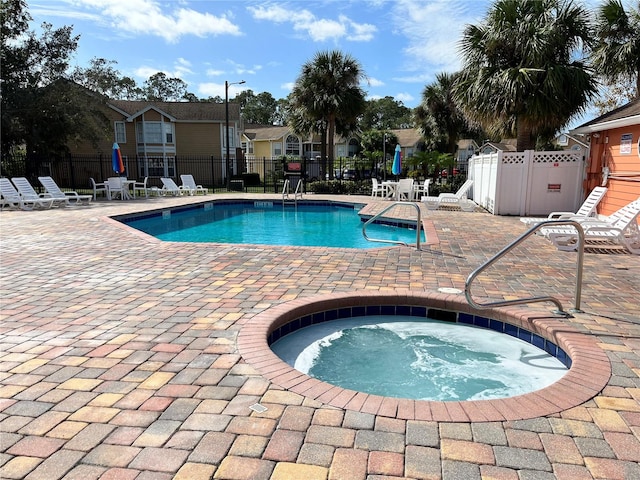 view of swimming pool with a community hot tub and a patio