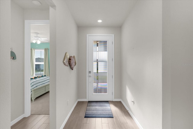 doorway featuring ceiling fan and light hardwood / wood-style flooring