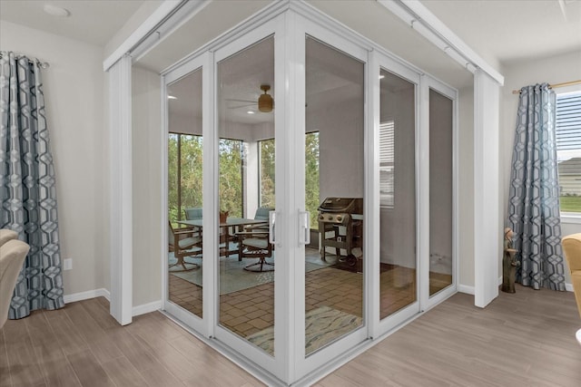 entryway with ceiling fan and light hardwood / wood-style floors