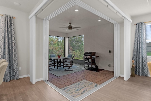 interior space with ceiling fan and light hardwood / wood-style floors