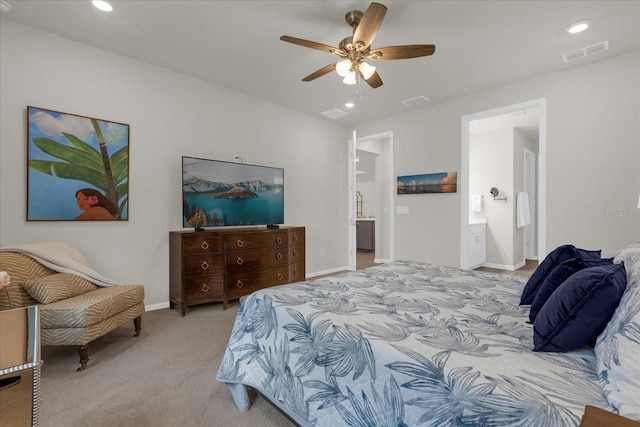 carpeted bedroom featuring ensuite bathroom and ceiling fan