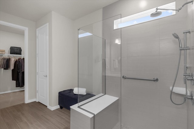 bathroom with hardwood / wood-style floors and tiled shower