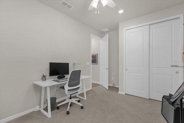 carpeted office space with ceiling fan