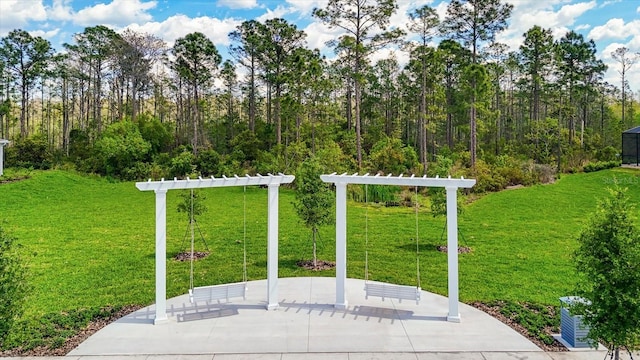 exterior space featuring a pergola and a lawn