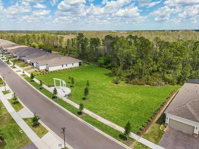 birds eye view of property with a view of trees