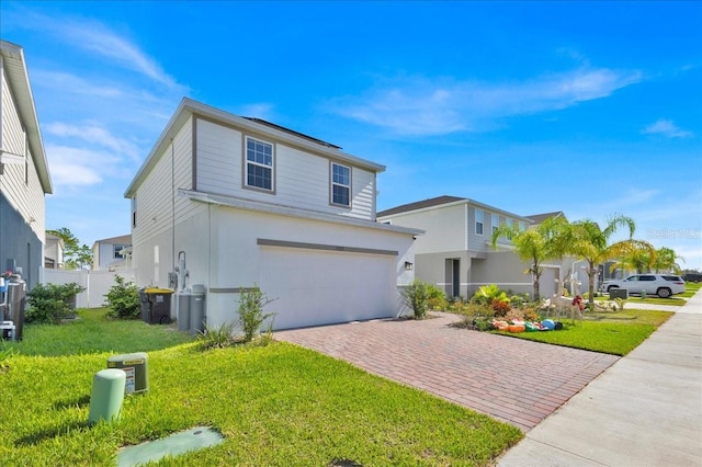 view of front facade featuring a garage and a front lawn