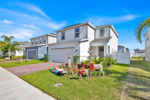 view of front of house featuring a garage and a front yard