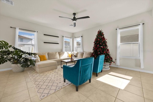 living room featuring ceiling fan, light tile patterned floors, and a wealth of natural light