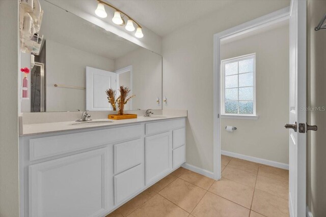 bathroom with tile patterned flooring and vanity