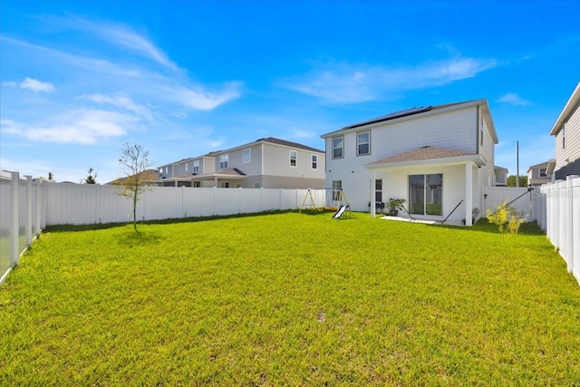 rear view of house featuring a yard