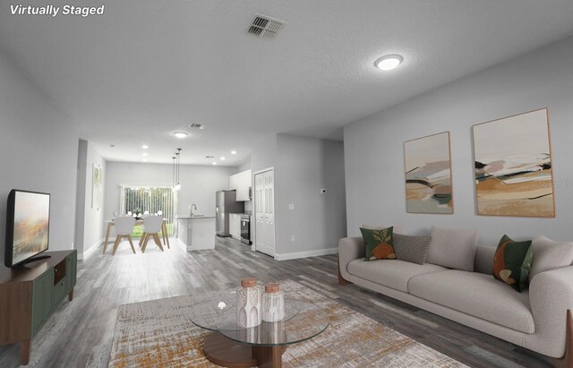 13869 SW 114th Pl, Dunnellon, FL 34432 - living area with wood finished floors, baseboards, and recessed lighting