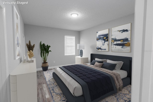 bedroom with hardwood / wood-style floors and a textured ceiling