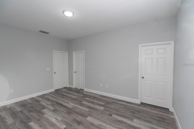 13869 SW 114th Pl, Dunnellon, FL 34432 - empty room with wood finished floors, a textured ceiling, and baseboards