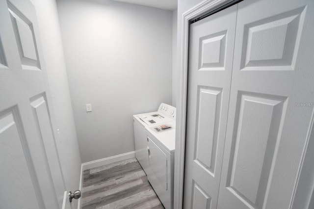 laundry area featuring light hardwood / wood-style flooring and washing machine and clothes dryer