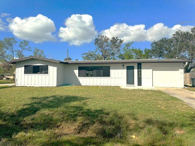 ranch-style home featuring a garage and a front lawn