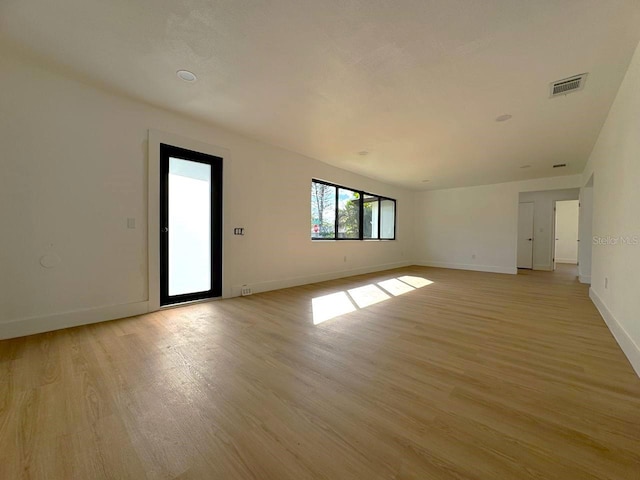 spare room featuring light hardwood / wood-style floors