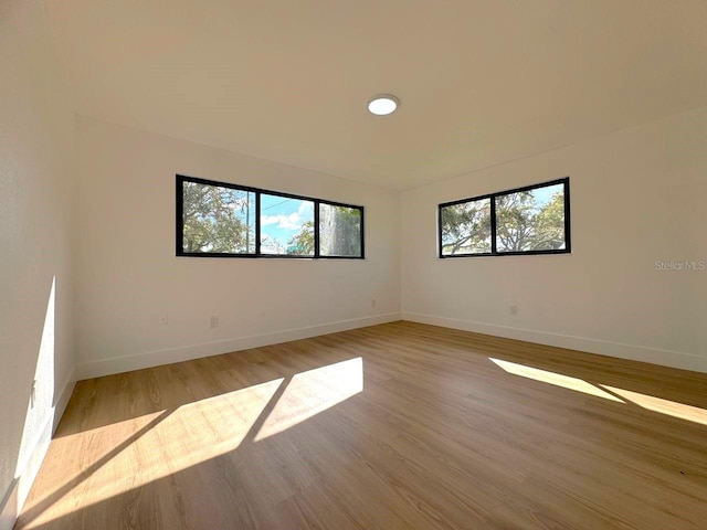 empty room with light hardwood / wood-style floors