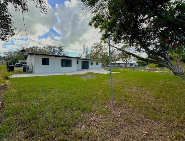 back of property featuring a lawn