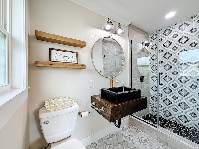 bathroom with sink, an enclosed shower, and toilet