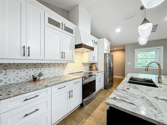 kitchen with white cabinetry, sink, pendant lighting, decorative backsplash, and appliances with stainless steel finishes