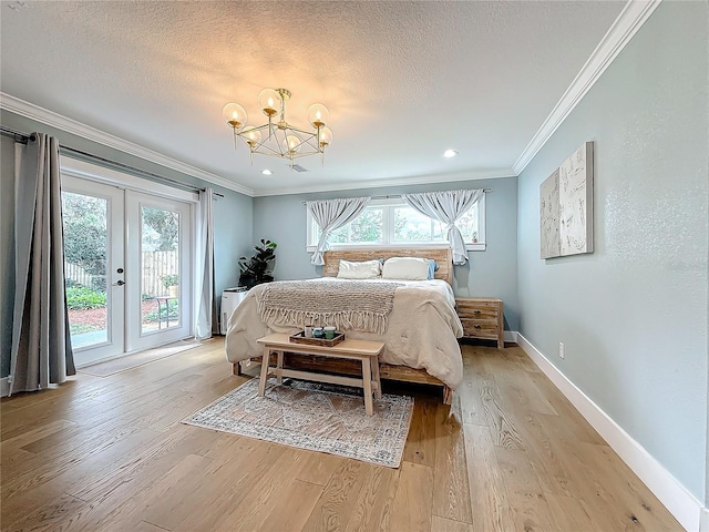 bedroom featuring access to outside, multiple windows, and light wood-type flooring