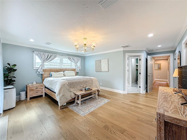 bedroom featuring light hardwood / wood-style flooring, a notable chandelier, and crown molding