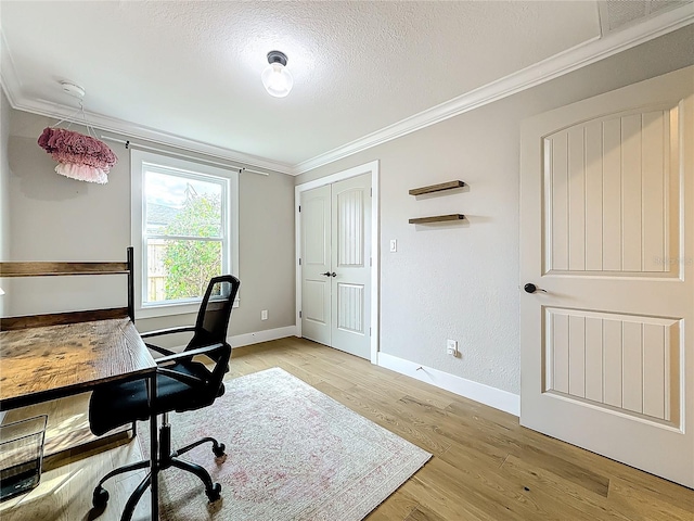 office area featuring light hardwood / wood-style flooring, a textured ceiling, and ornamental molding