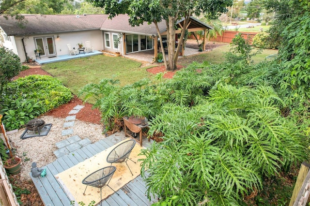 view of yard featuring a wooden deck and french doors