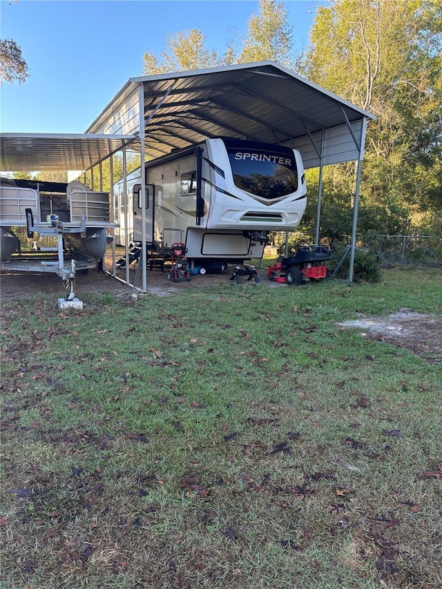 view of vehicle parking with a yard and a carport