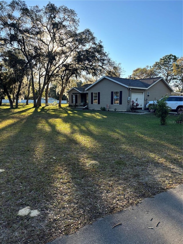 view of front facade with a garage and a front lawn