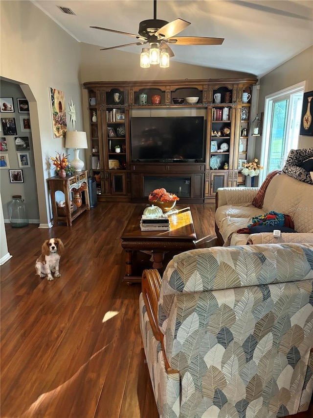 living room with ceiling fan, dark hardwood / wood-style flooring, and lofted ceiling