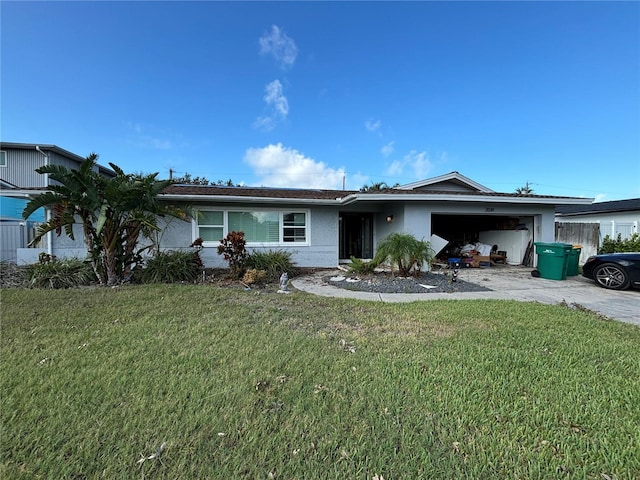 single story home featuring a garage and a front lawn