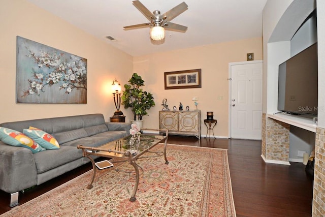 living room featuring dark hardwood / wood-style floors and ceiling fan