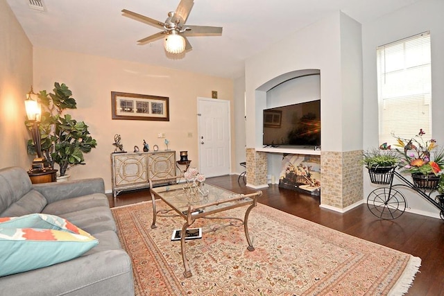 living room featuring ceiling fan and dark hardwood / wood-style flooring