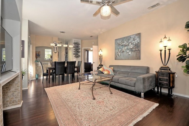 living room featuring ceiling fan and dark hardwood / wood-style flooring