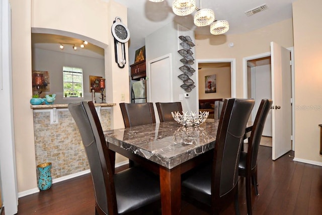 dining space featuring dark hardwood / wood-style flooring