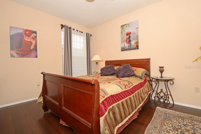 bedroom with dark hardwood / wood-style flooring