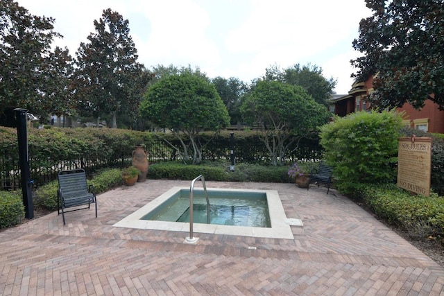 view of pool featuring a patio and a hot tub