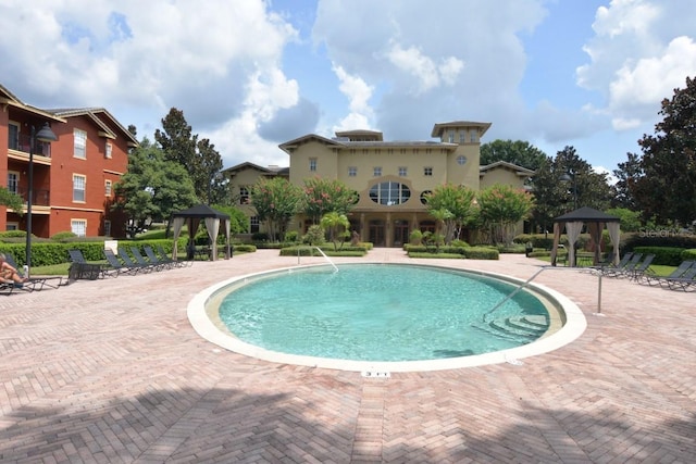 view of pool with a patio and a gazebo