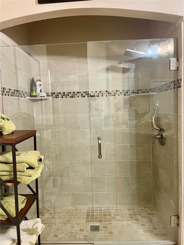 bathroom with a shower with shower door