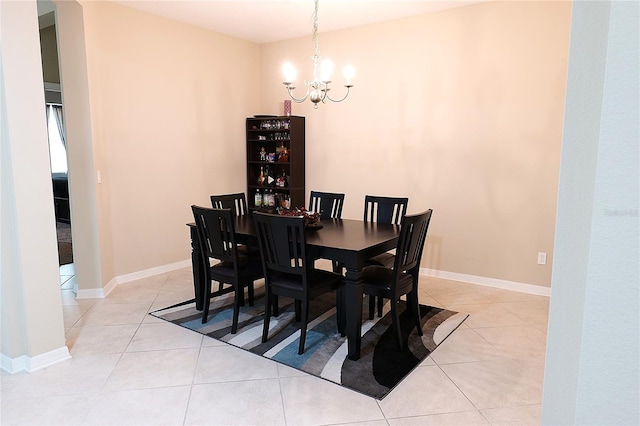 dining room featuring light tile patterned floors and an inviting chandelier