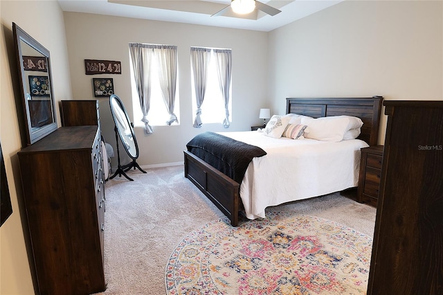 bedroom featuring ceiling fan and light carpet