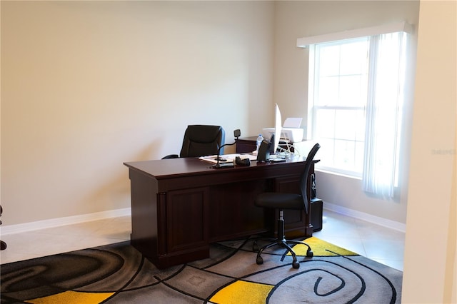 tiled office space featuring a healthy amount of sunlight