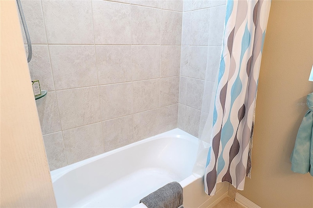 bathroom with shower / tub combo with curtain