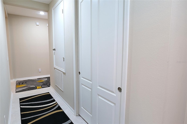 corridor featuring light tile patterned floors