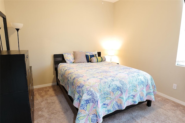 bedroom featuring light carpet