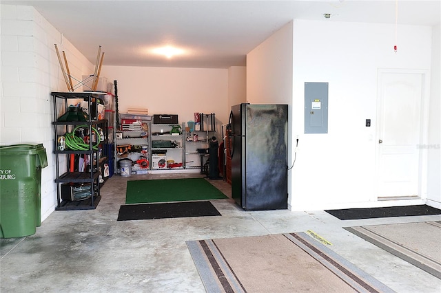 garage featuring black refrigerator and electric panel