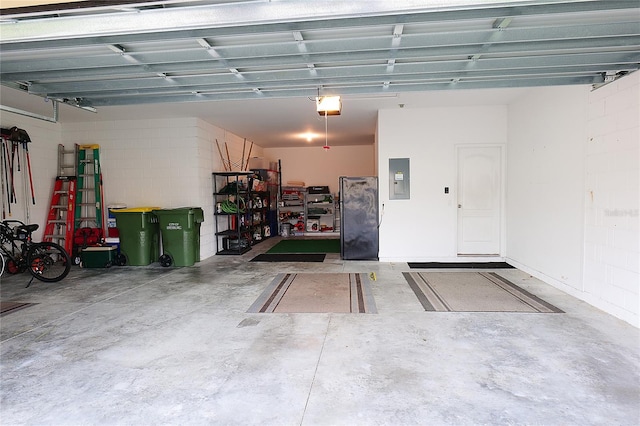 garage with electric panel and a garage door opener